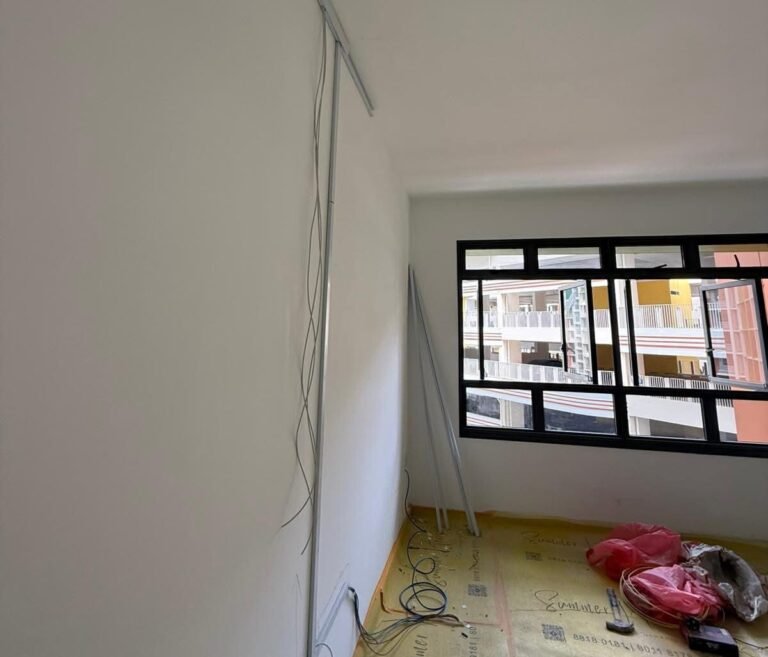 New cable run down the wall to a power point location in a Singapore HDB bedroom