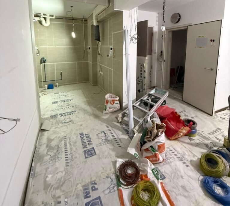 HDB kitchen under renovation with electrical wiring and power points being installed in Singapore