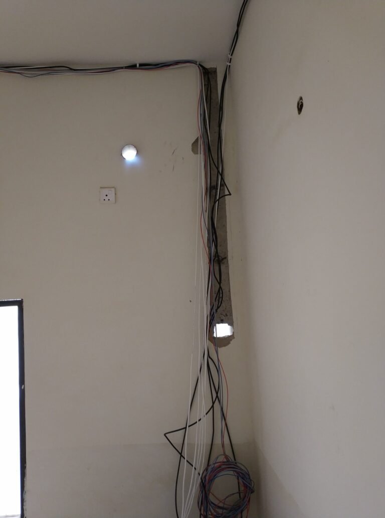Cable bundle run to a ceiling downlight point during lighting installation in Singapore