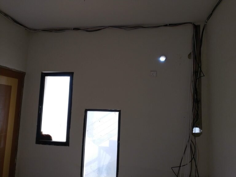 Concealed wiring along the ceiling edge for downlight installation in a Singapore home