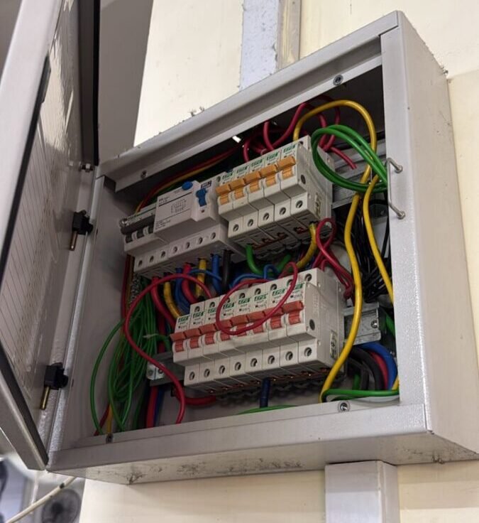 Close-up of a DB box with neatly arranged circuit breakers and colour-coded wiring in Singapore