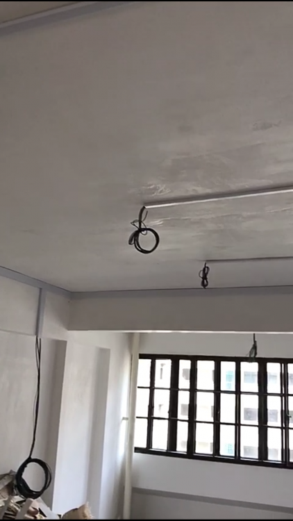 Ceiling light point with coiled wire ready for lighting installation in a Singapore home