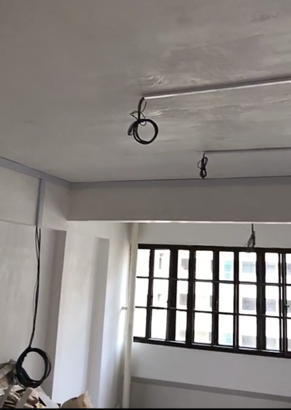 Coiled wire at a ceiling point ready for light or fan installation in a Singapore flat