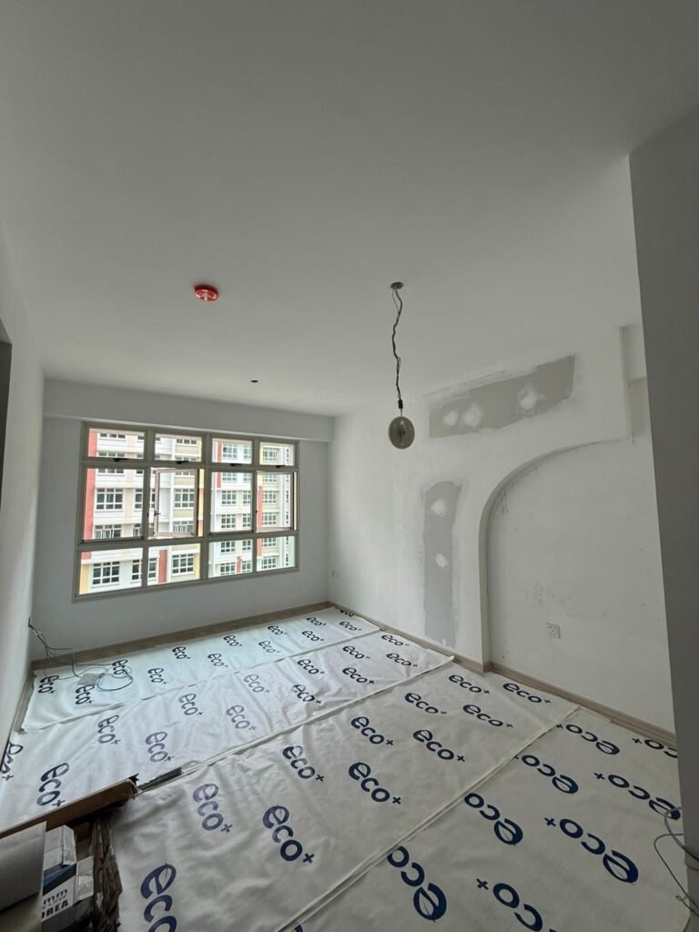 HDB bedroom with ceiling light point and floor protection during electrical rewiring in Singapore