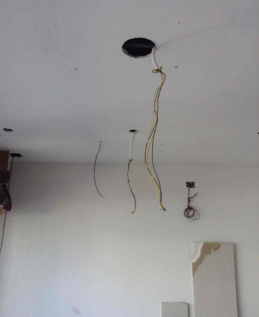 Ceiling light point with wires prepared for lighting installation in a Singapore home