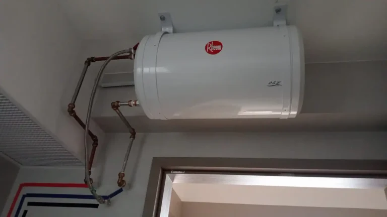 Rheem storage water heater installed on a bathroom wall with copper pipes in a Singapore HDB flat