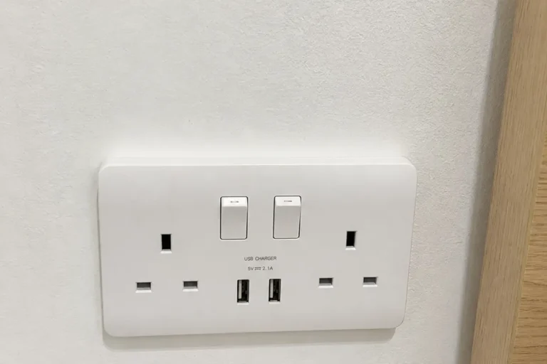 Matching switch and USB power point plates fitted together in a Singapore home