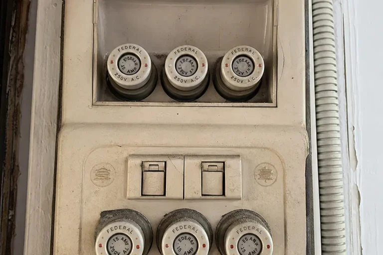 Old ceramic fuse box due for replacement with a modern breaker DB box